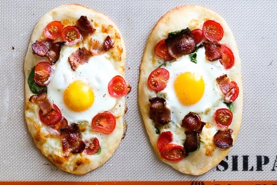 This easy, homemade breakfast pizza is made with bacon, eggs, tomatoes, spinach and cheese, made completely from scratch and ready in less than 30 minutes start to finish!
