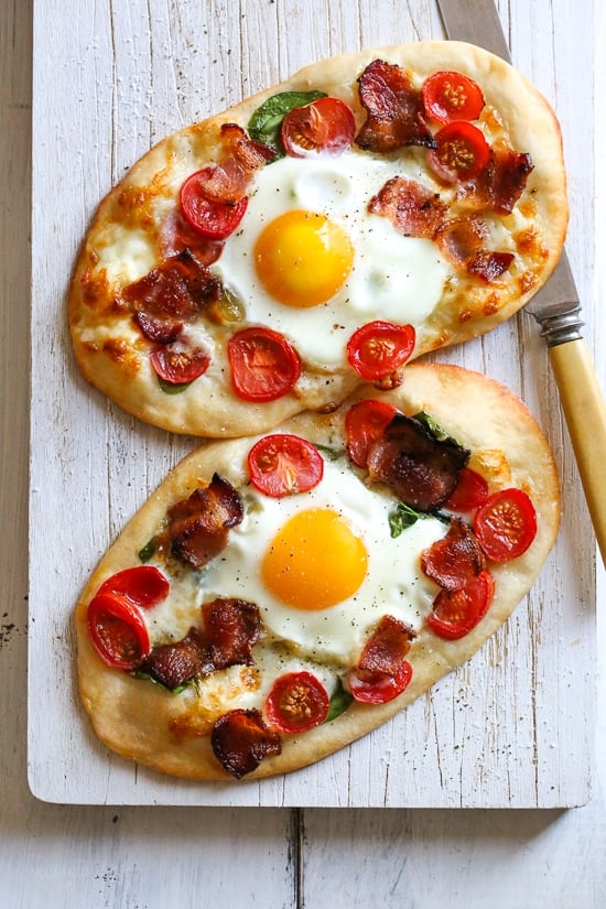 This easy, homemade breakfast pizza is made with bacon, eggs, tomatoes, spinach and cheese, made completely from scratch and ready in less than 30 minutes start to finish!