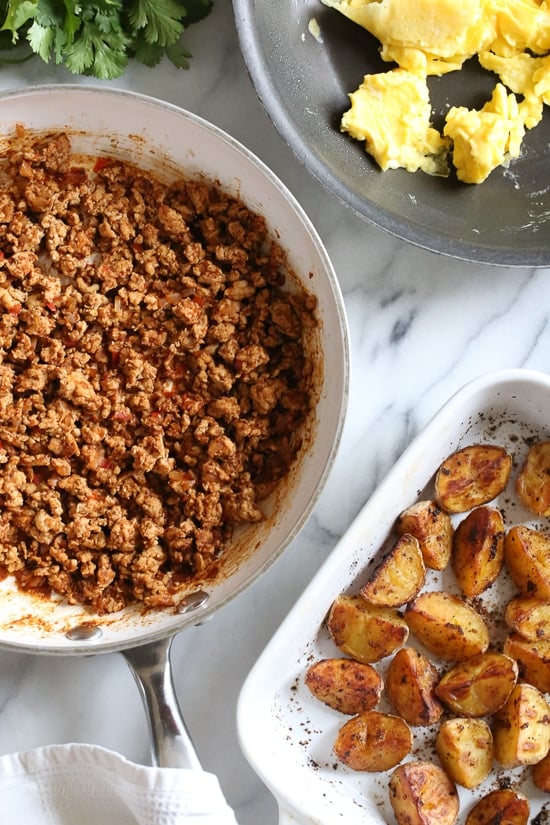 Breakfast lovers, jazz up your mornings with this Meal Prep Breakfast Taco Scramble, made with potatoes, turkey taco meat, scrambled eggs and salsa (cheese is optional!) perfect to make ahead for breakfast for the week!