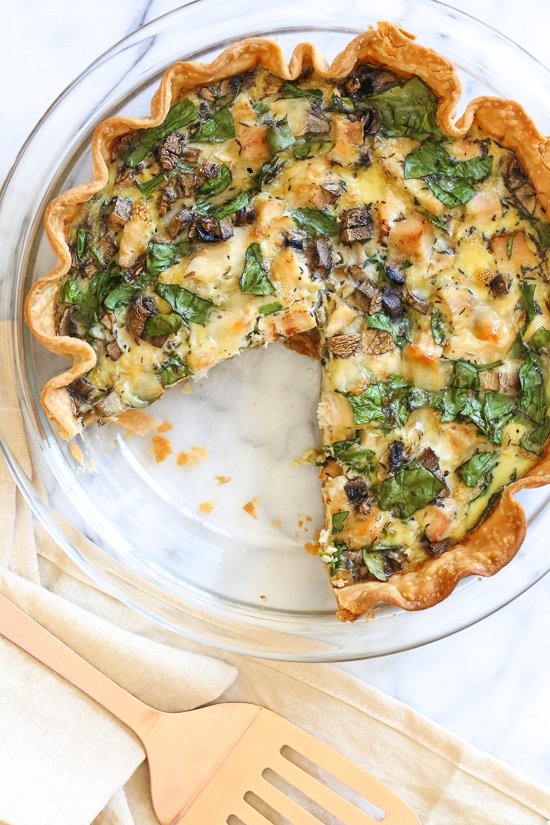 This easy lighter chicken quiche is made with refrigerated pie crust and loaded with spinach and mushrooms but you can use any combination of vegetables. A great recipe to clean out the refrigerator!
