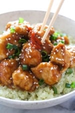 General Tso's chicken in bowl with cauliflower rice