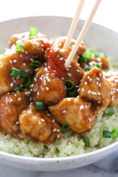 General Tso's chicken in bowl with cauliflower rice