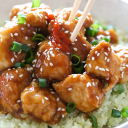 General Tso's chicken in bowl with cauliflower rice