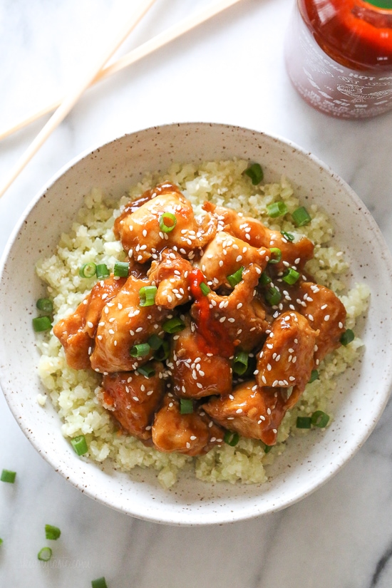 Top-down view of General Tso's chicken in bowl of cauliflower rice
