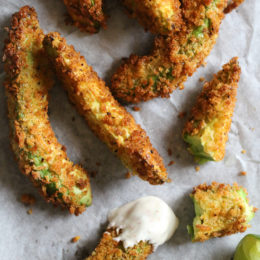 Crispy baked avocado fries coated with panko breadcrumbs with a lime dipping sauce. So fast and easy to make in the oven or air fryer!