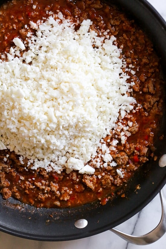 Skillet Taco Cauliflower Rice, an easy skillet dinner made with ground turkey and cauliflower rice topped with lettuce, avocado and salsa for an low-carb, weeknight meal!