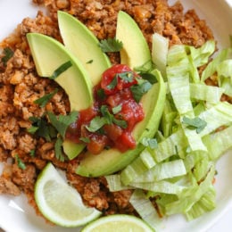 This easy skillet dinner combines ground turkey taco meat with cauliflower rice topped with lettuce, avocado and salsa for an easy, low-carb weeknight meal!