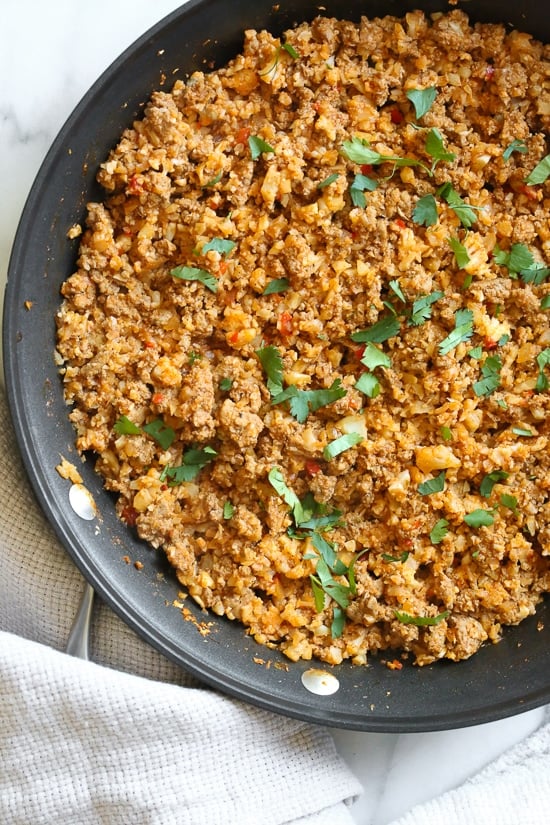 Skillet Taco Cauliflower Rice, an easy skillet dinner made with ground turkey and cauliflower rice topped with lettuce, avocado and salsa for an low-carb, weeknight meal!