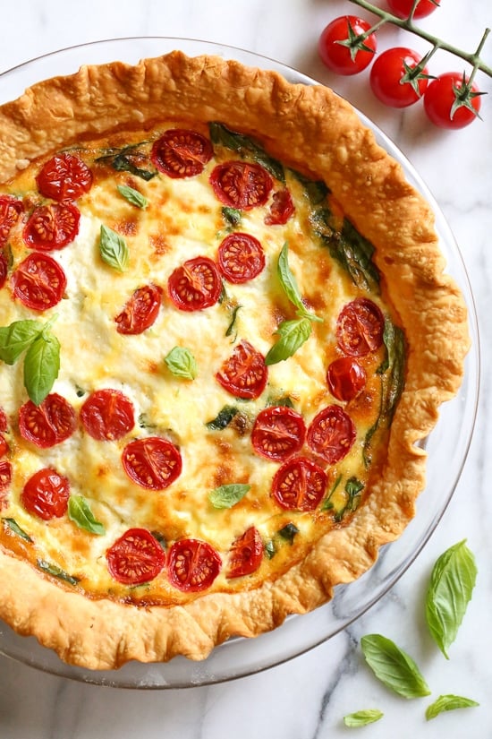 This easy vegetarian quiche recipe is made with spinach, ricotta cheese, eggs, tomatoes and basil. Perfect for breakfast, lunch or brunch or serve it with a salad for a light dinner.