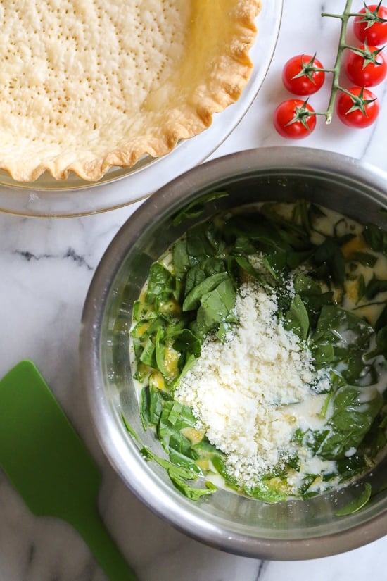 This easy vegetarian quiche recipe is made with spinach, ricotta cheese, eggs, tomatoes and basil. Perfect for breakfast, lunch or brunch or serve it with a salad for a light dinner.