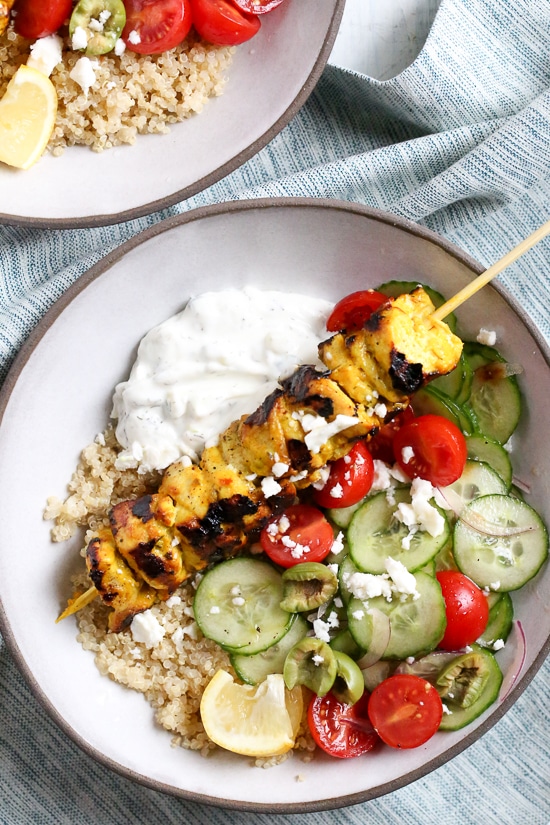 Smoky yogurt-marinated grilled chicken served over quinoa and Mediterranean-inspired tomatoes, cucumbers, and olives with tzatziki and Feta.