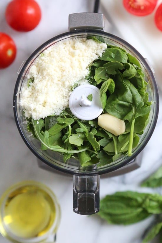 This fresh basil pesto is made with basil, garlic and Parmesan. Leaving out the pine nuts and reducing the olive oil makes it lighter! Ingredients for fresh basil pesto in food processor