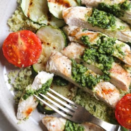 Grilled chicken, zucchini and tomatoes topped with a light spinach-arugula basil pesto served over couscous.