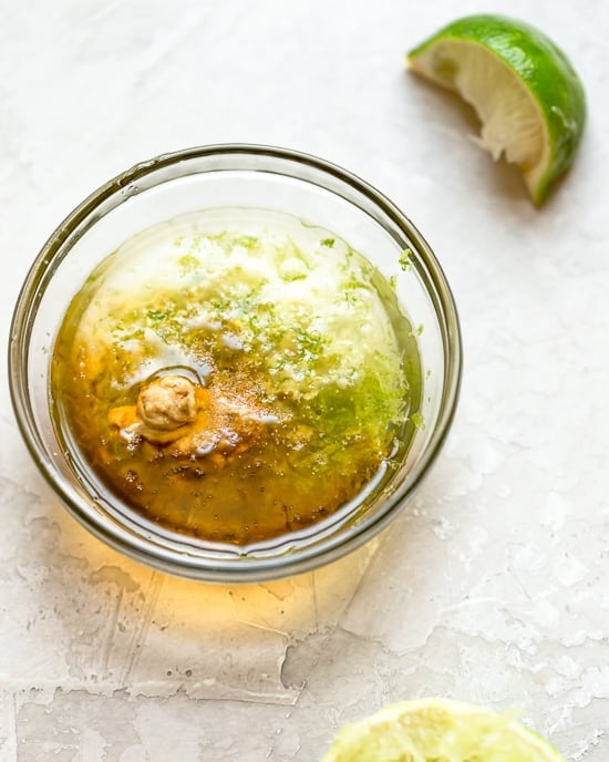 Grilled Chicken Salad with greens and vegetables are tossed in a honey-lime vinaigrette and topped with a delicious peanut sauce.