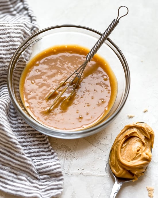 Grilled Chicken Salad with greens and vegetables are tossed in a honey-lime vinaigrette and topped with a delicious peanut sauce.