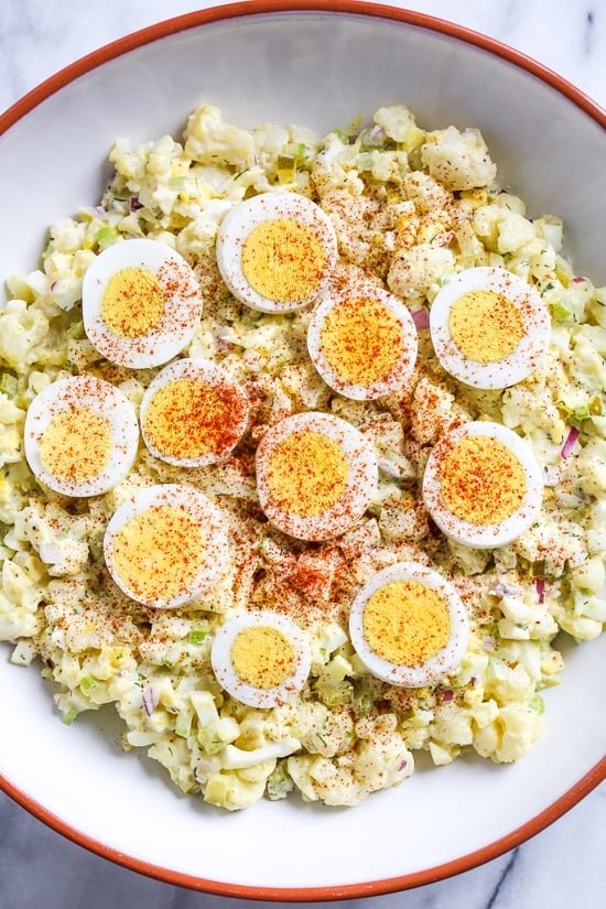 A low-carb faux "potato" salad made with cauliflower instead of potatoes, perfect for Keto or if you're just looking to eat less carbs.
