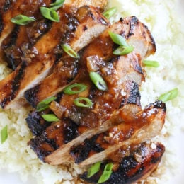 Grilled Bourbon Chicken breasts are marinaded with soy sauce, Bourbon, brown sugar, ginger and spices then grilled until slightly caramelized on the outside and juicy on the inside.