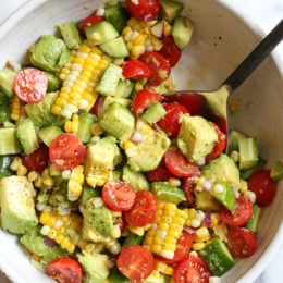 perfect summer corn salad with avocado, cucumbers and tomato