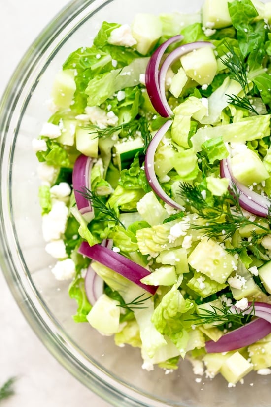 Chopped salad with romaine lettuce, Feta cheese, cucumbers, red onion and dill tossed with a simple red wine vinaigrette. An easy side salad to go with all your Mediterranean dishes.