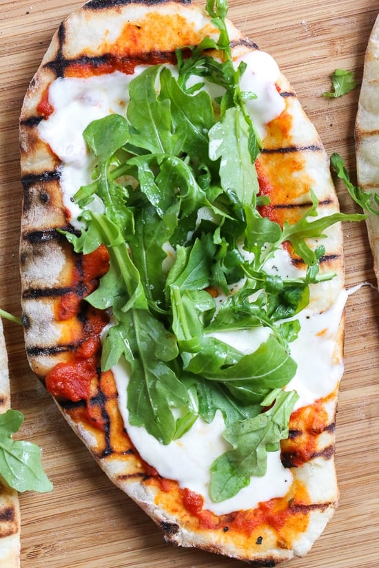 This easy Grilled Pizza is made from scratch with my easy yeast-free Greek yogurt dough, topped with sauce, mozzarella cheese and your choice of toppings. A great summer outdoor meal that whole family can enjoy!
