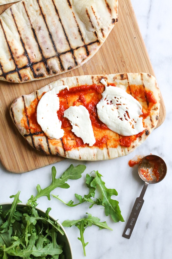 This easy Grilled Pizza is made from scratch with my easy yeast-free Greek yogurt dough, topped with sauce, mozzarella cheese and your choice of toppings. A great summer outdoor meal that whole family can enjoy!