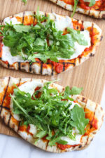 This easy Grilled Pizza is made from scratch with my easy yeast-free Greek yogurt dough, topped with sauce, mozzarella cheese and your choice of toppings. A great summer outdoor meal that whole family can enjoy!