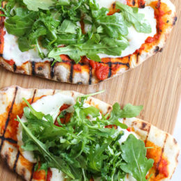 This easy Grilled Pizza is made from scratch with my easy yeast-free Greek yogurt dough, topped with sauce, mozzarella cheese and your choice of toppings. A great summer outdoor meal that whole family can enjoy!