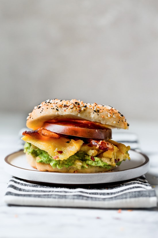 Bacon, egg and avocado on a bagel is my favorite breakfast sandwich made with scrambled eggs, center cut bacon and sliced tomatoes on my homemade bagels.