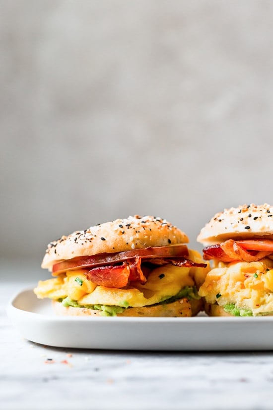Bacon, egg and avocado on a bagel is my favorite breakfast sandwich made with scrambled eggs, center cut bacon and sliced tomatoes on my homemade bagels.