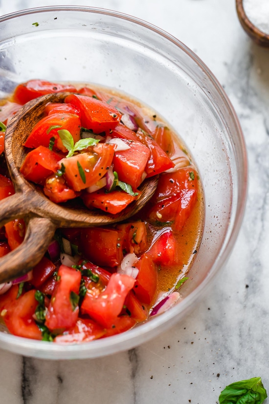 Ripe, end-of-summer garden tomatoes make the best, juiciest tomato salad, perfect served with a rustic loaf of bread!
