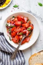 Ripe, end-of-summer garden tomatoes make the best, juiciest tomato salad, perfect served with a rustic loaf of bread!