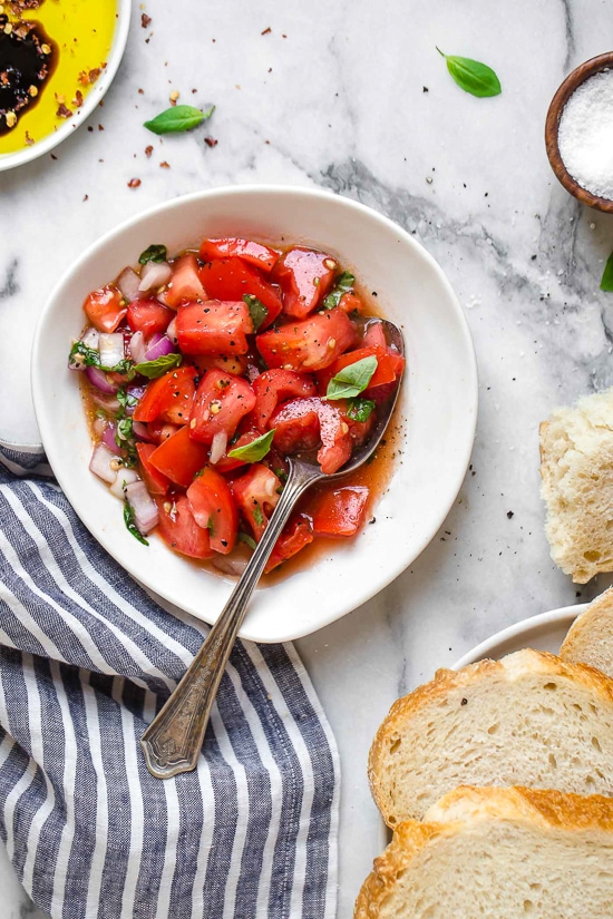 Ripe, end-of-summer garden tomatoes make the best, juiciest tomato salad, perfect served with a rustic loaf of bread!