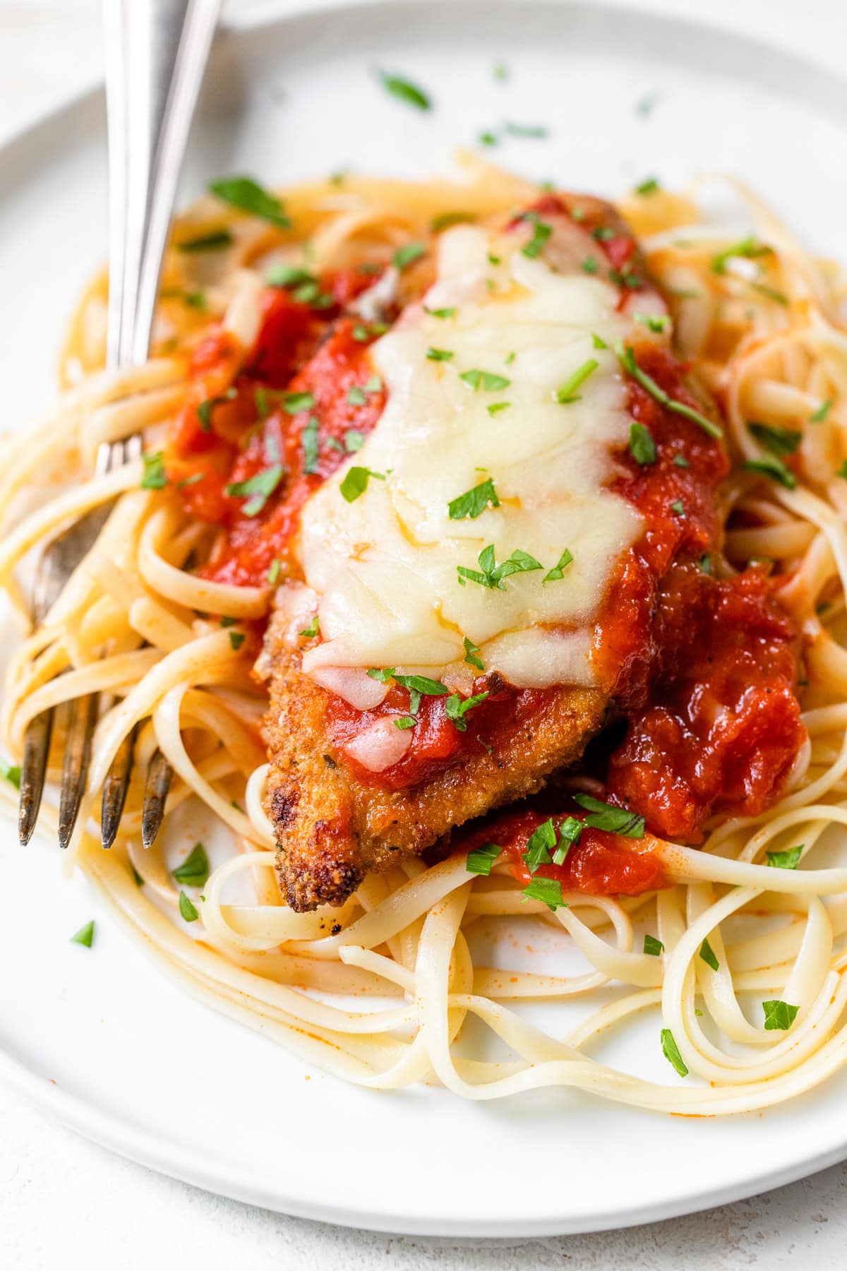 Chicken Parmesan with pasta and a fork