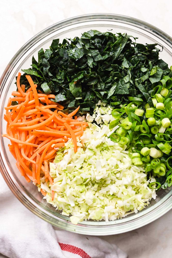 Houston’s (Lightened-Up) Kale Salad with Peanut Vinaigrette is satisfying, made with a combo of grilled chicken, kale, cabbage, carrots, peanuts, scallions, cilantro and mint tossed in a light peanut-sesame dressing.