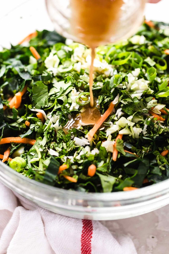 Houston’s (Lightened-Up) Kale Salad with Peanut Vinaigrette is satisfying, made with a combo of grilled chicken, kale, cabbage, carrots, peanuts, scallions, cilantro and mint tossed in a light peanut-sesame dressing.