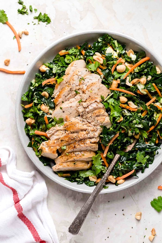 Houston’s (Lightened-Up) Kale Salad with Peanut Vinaigrette is satisfying, made with a combo of grilled chicken, kale, cabbage, carrots, peanuts, scallions, cilantro and mint tossed in a light peanut-sesame dressing.