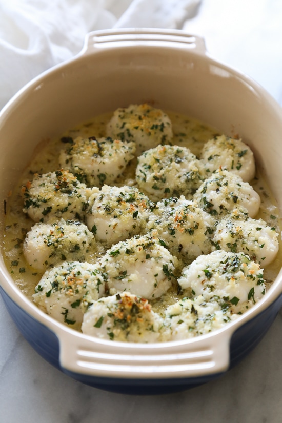 These quick and easy baked sea scallops are topped with panko and Parmesan in a simple lemon-butter sauce.
