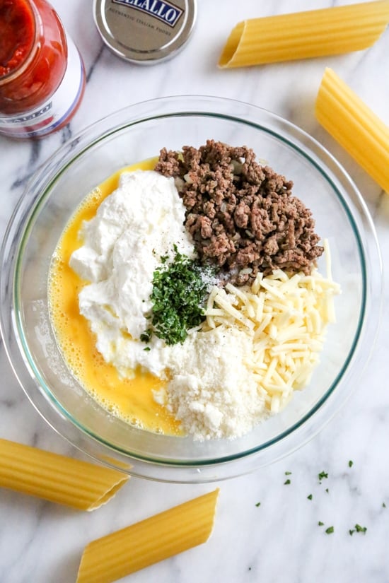 This easy no-boil baked manicotti pasta dish, known as Cannelloni is stuffed with ricotta, parmesan, mozzarella and lean ground beef, then covered in sauce and cheese. Perfect for the holidays, for to bring to a potluck or to enjoy any night of the week!