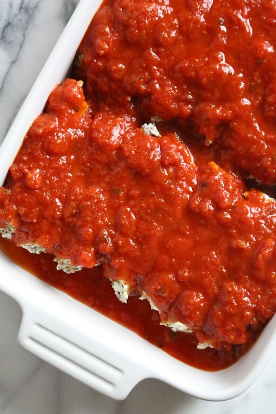 This easy no-boil baked manicotti pasta dish, known as Cannelloni is stuffed with ricotta, parmesan, mozzarella and lean ground beef, then covered in sauce and cheese. Perfect for the holidays, for to bring to a potluck or to enjoy any night of the week!