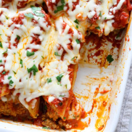 This easy no-boil baked manicotti pasta dish, known as Cannelloni is stuffed with ricotta, parmesan, mozzarella and lean ground beef, then covered in sauce and cheese. Perfect for the holidays, for to bring to a potluck or to enjoy any night of the week!