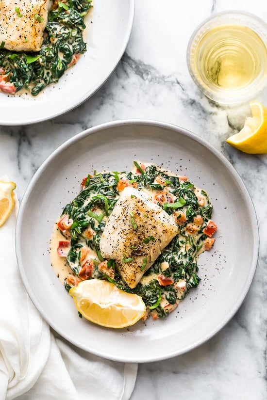 This easy Fish Florentine recipe, made with a pan seared firm white fish served on a creamy bed of spinach feels like something you would order out in a fancy restaurant!