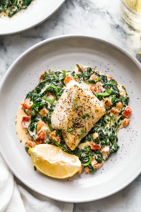 This easy Fish Florentine recipe, made with a pan seared firm white fish served on a creamy bed of spinach feels like something you would order out in a fancy restaurant!