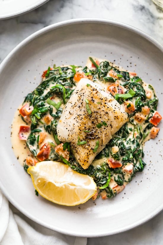 This easy Fish Florentine recipe, made with a pan seared firm white fish served on a creamy bed of spinach feels like something you would order out in a fancy restaurant!