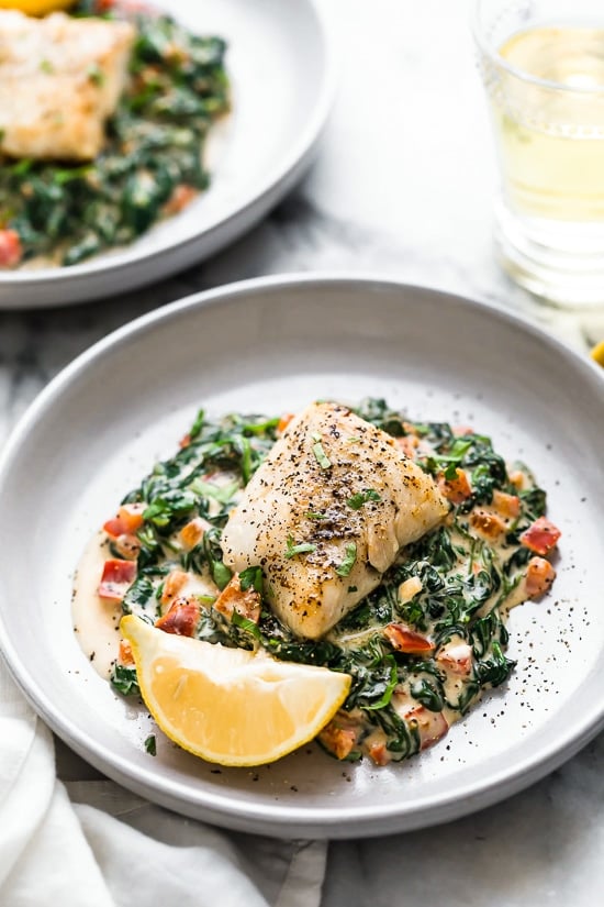 This easy Fish Florentine recipe, made with a pan seared firm white fish served on a creamy bed of spinach feels like something you would order out in a fancy restaurant!