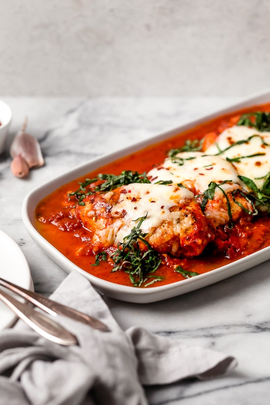 This quick and easy Instant Pot Chicken Parmesan is ready in minutes, with no breading or frying. Perfect for busy weeknights! Instant Pot chicken parmesan in a serving tray