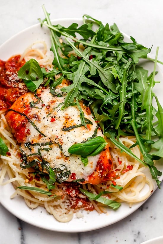 This quick and easy Instant Pot Chicken Parmesan is ready in minutes, with no breading or frying. Perfect for busy weeknights! Instant Pot chicken parmesan over a bed of spaghetti