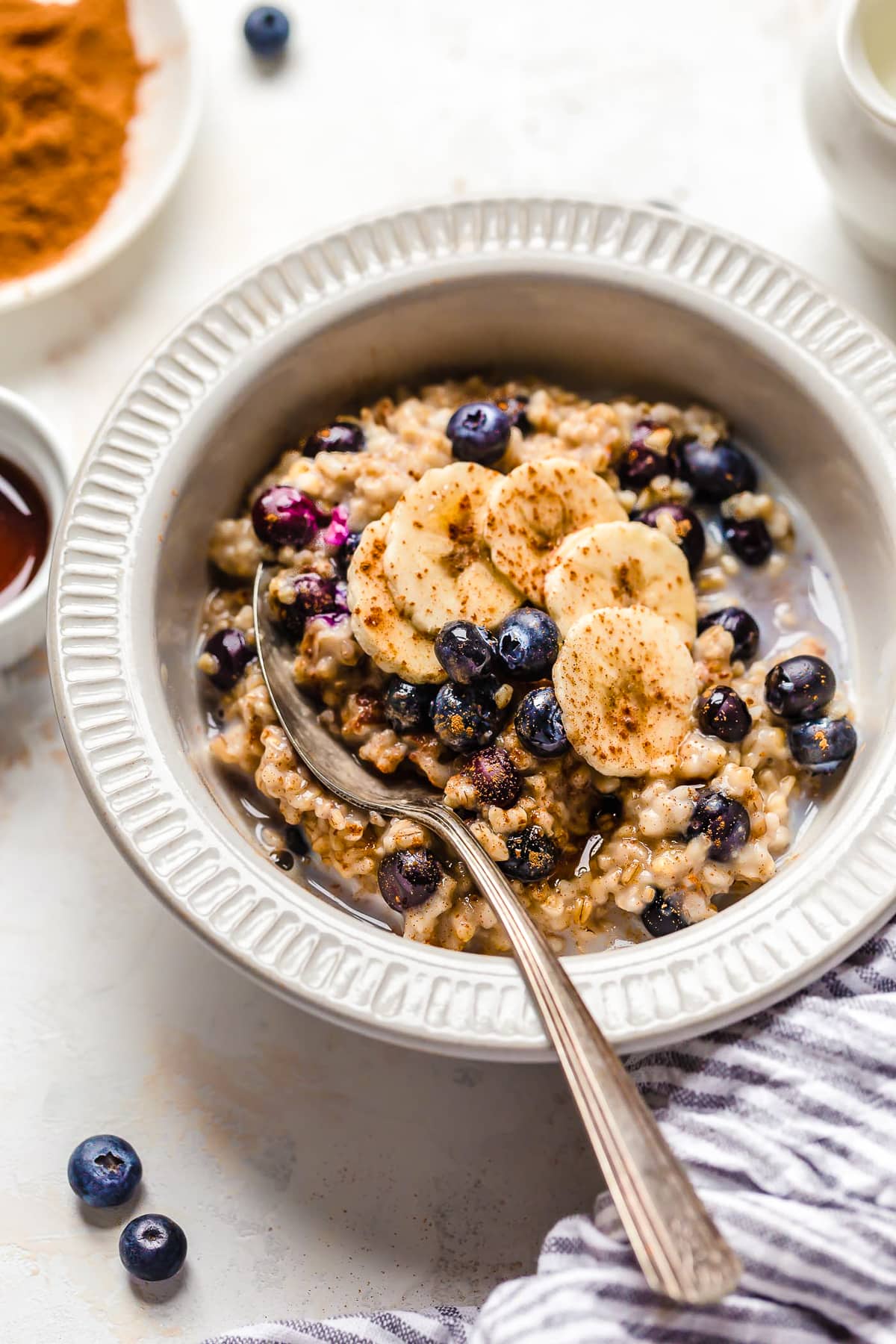 A warm and heart healthy breakfast, making Steel Cut Oats in the Instant Pot is so much faster than making them on the stove! Overhead view of a bowl of steel cut oats with blueberries and banana slices.