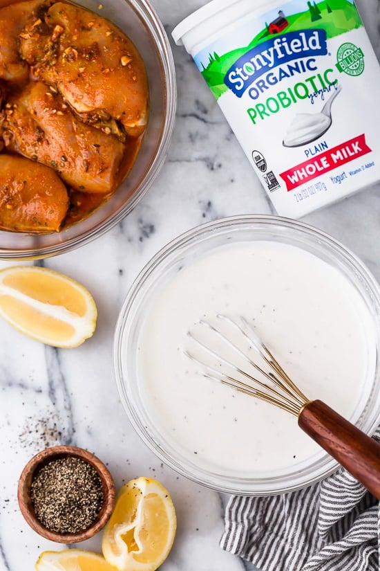 Halal Food Cart inspired chicken served over a big salad of lettuce and tomatoes drizzled with a yummy white sauce.