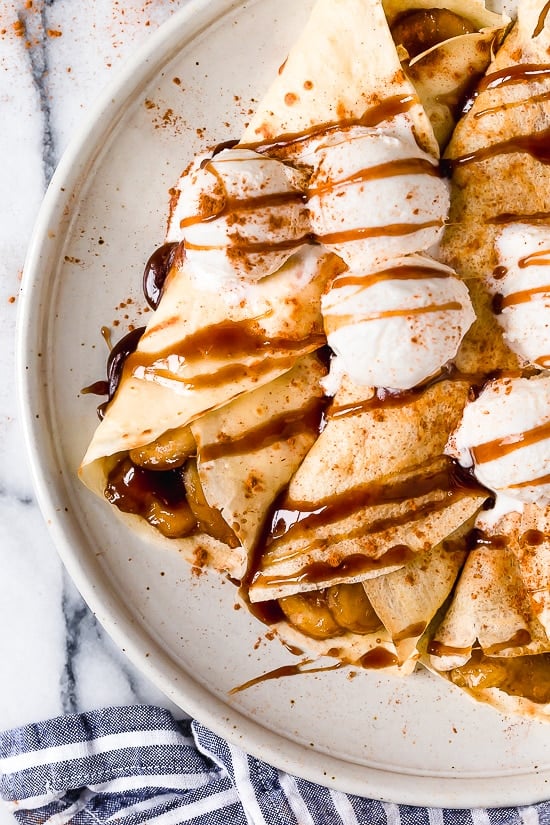 Banana Foster Crepes combine two of my favorite desserts – homemade crepes and bananas fosters! This slimmed down make-over is delicious and perfect anytime you're craving something sweet!