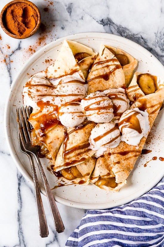Banana Foster Crepes combine two of my favorite desserts – homemade crepes and bananas fosters! This slimmed down make-over is delicious and perfect anytime you're craving something sweet!